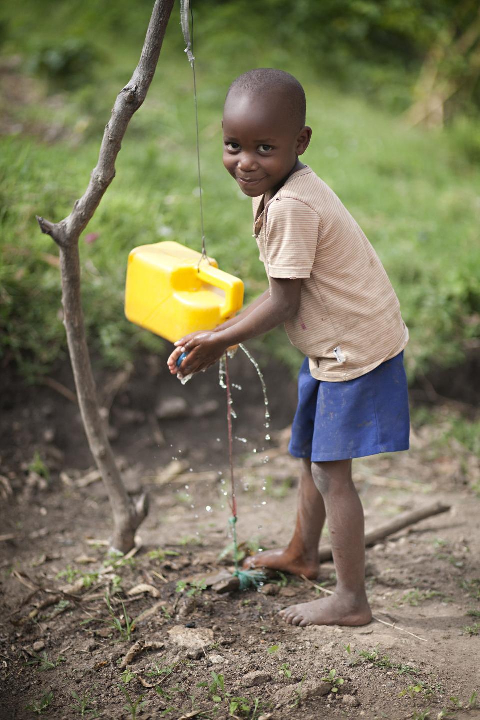 child using a tippy tap